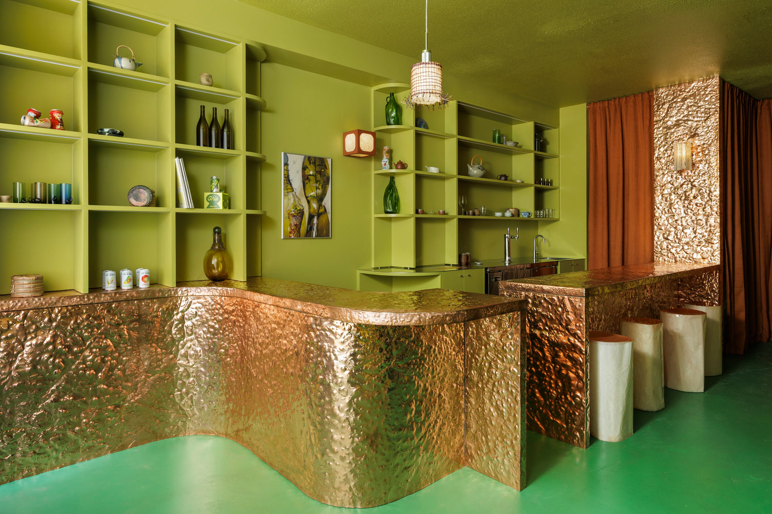 Interior view of Softer Drink Shop, with shelving and copper bar.