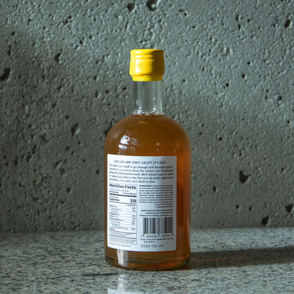 Rear label of Gnista non-alcoholic spirit bottle listing ingredients and descriptive text: "JUST LIKE ANY SPIRIT. EXCEPT IT'S NOT."