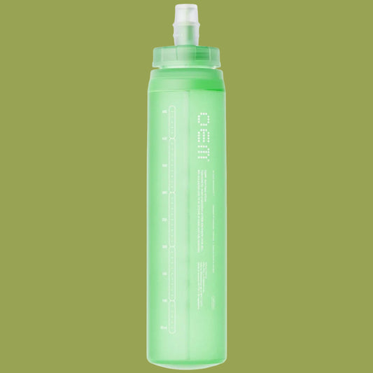 Green water bottle with a white cap on a white background
